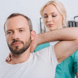 portrait-of-physiotherapist-stretching-mans-arm-in-hospital-1-e1683702230509.jpg